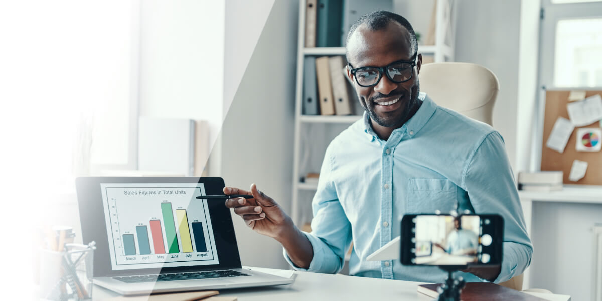 Man pointing at data on laptop
